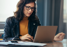 Woman sitting and working at the laptop